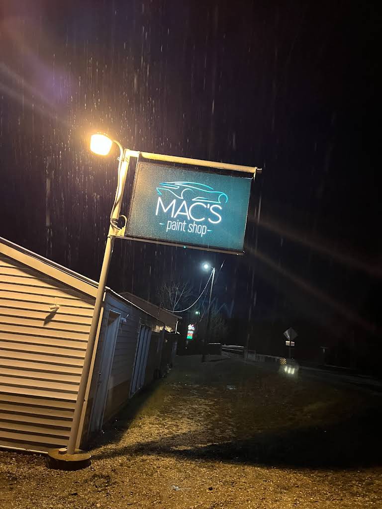 Mac's Paint Shop sign at night